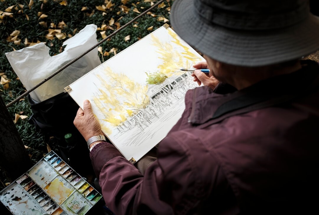 elderly woman painting on canvas