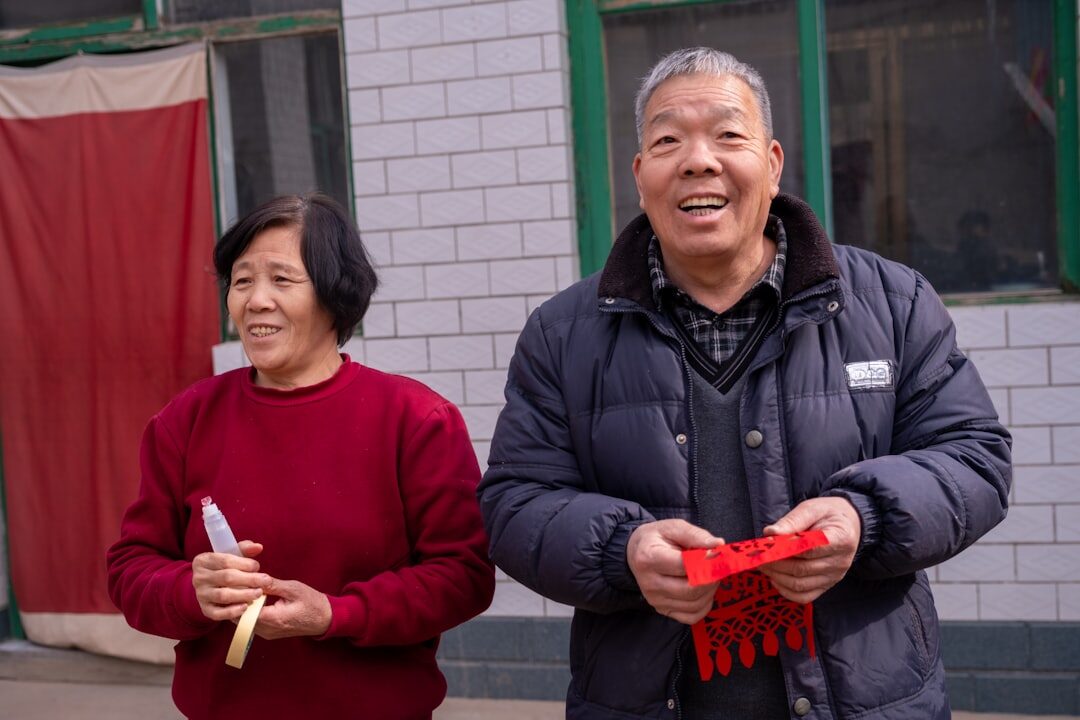 Seniors celebrating together holding membership cards at a community event