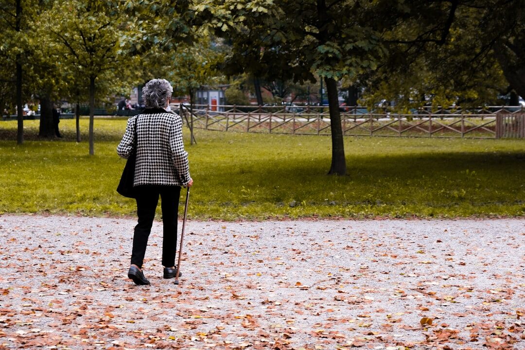 elderly person walking in park