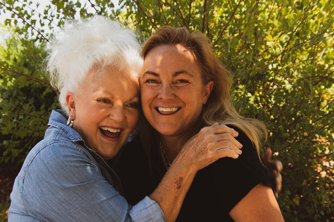Group of smiling Croatian seniors laughing together outdoors at a community event
