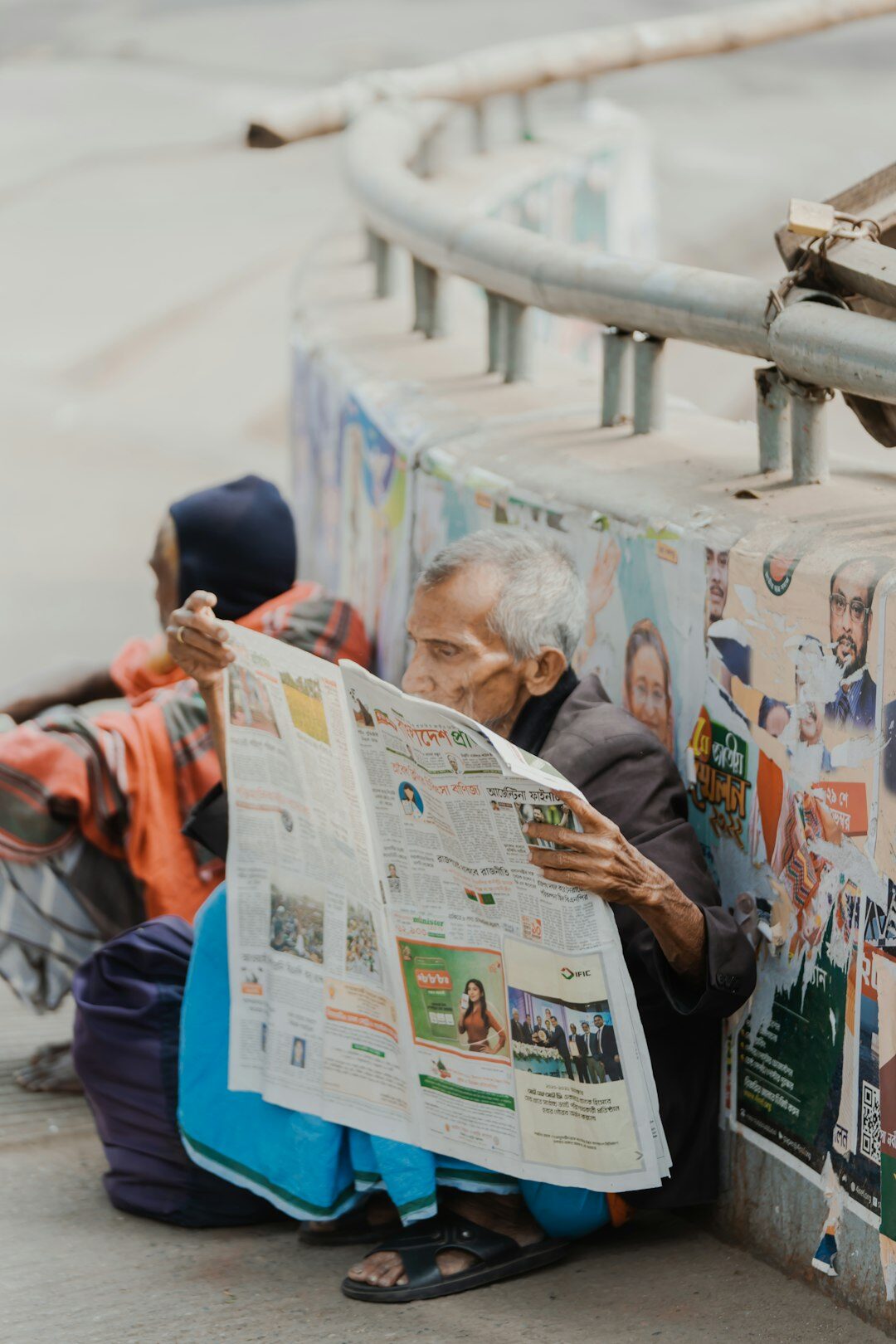 elderly people reading newspaper