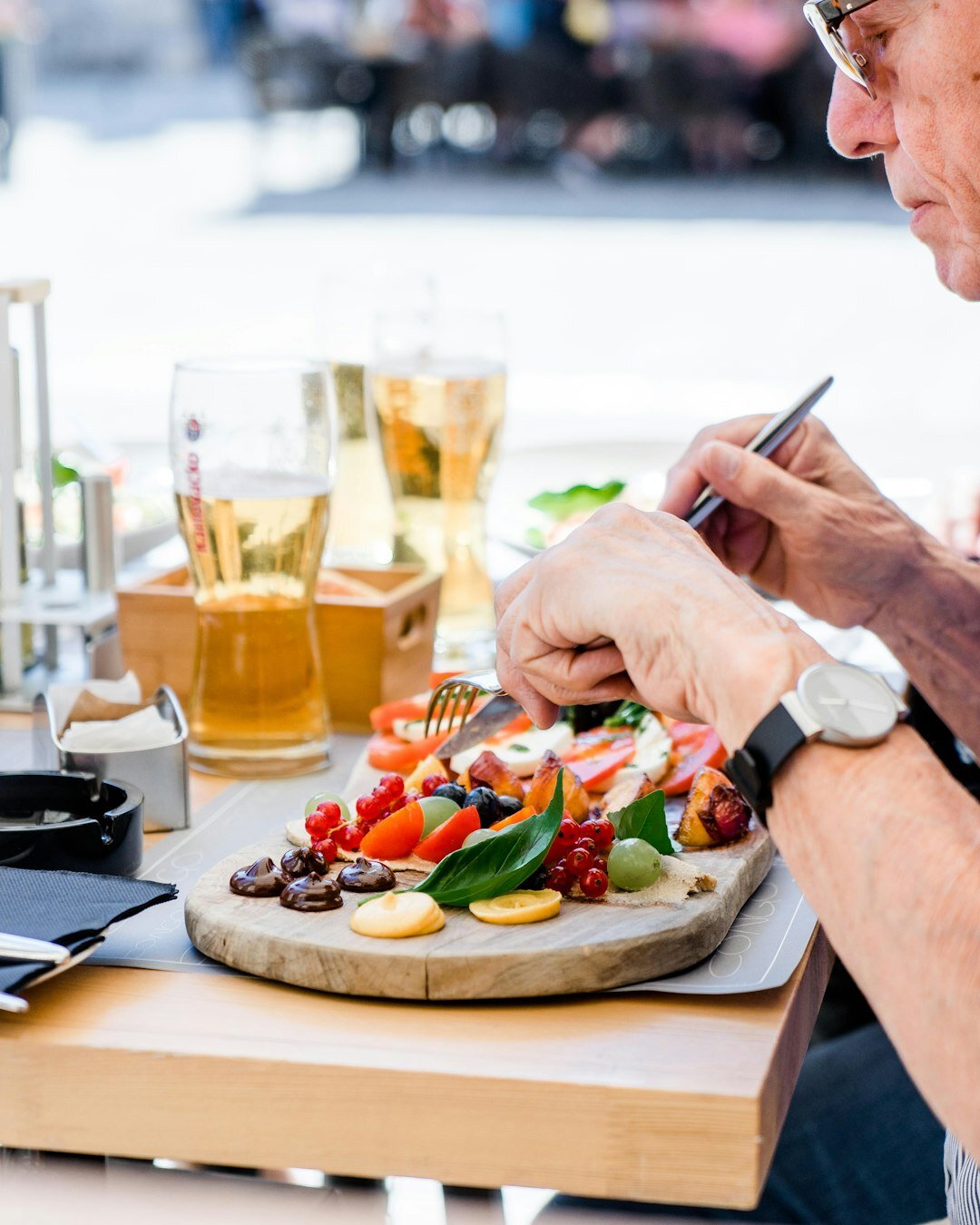 Croatian seniors enjoying lunch together at a long wooden table indoors