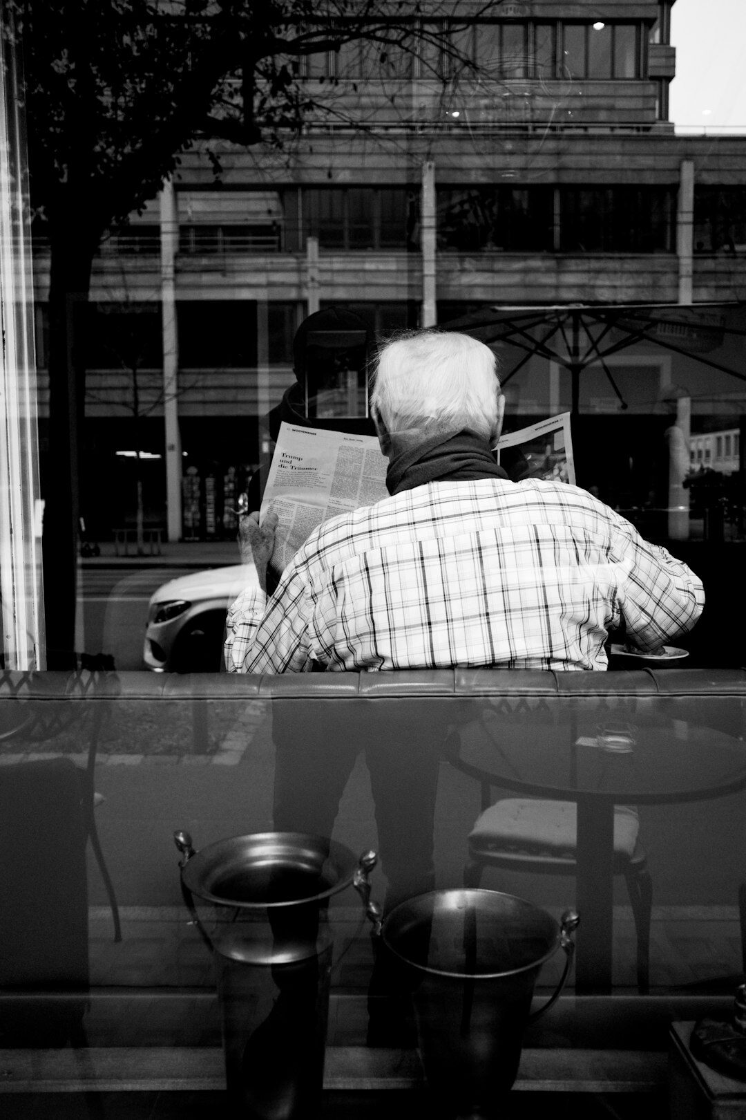 elderly couple reading newspaper