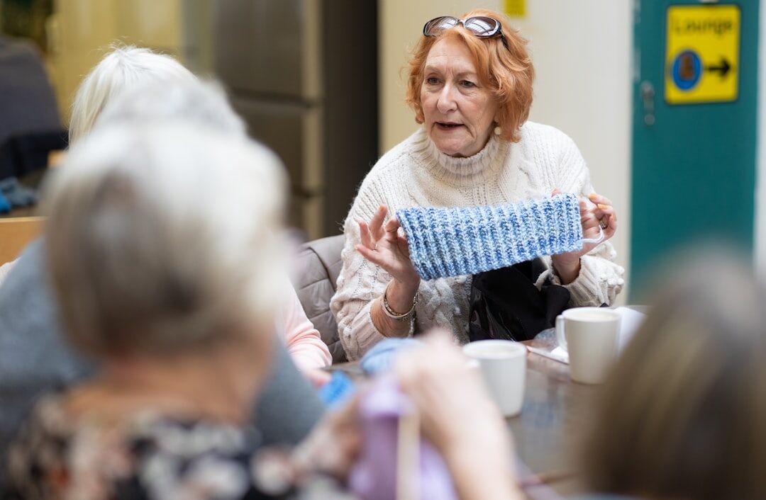 Senior woman teaching a small computer class to fellow seniors